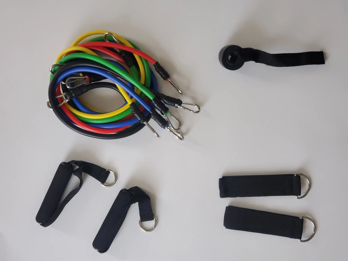Set of colorful resistance bands and black straps on a white background