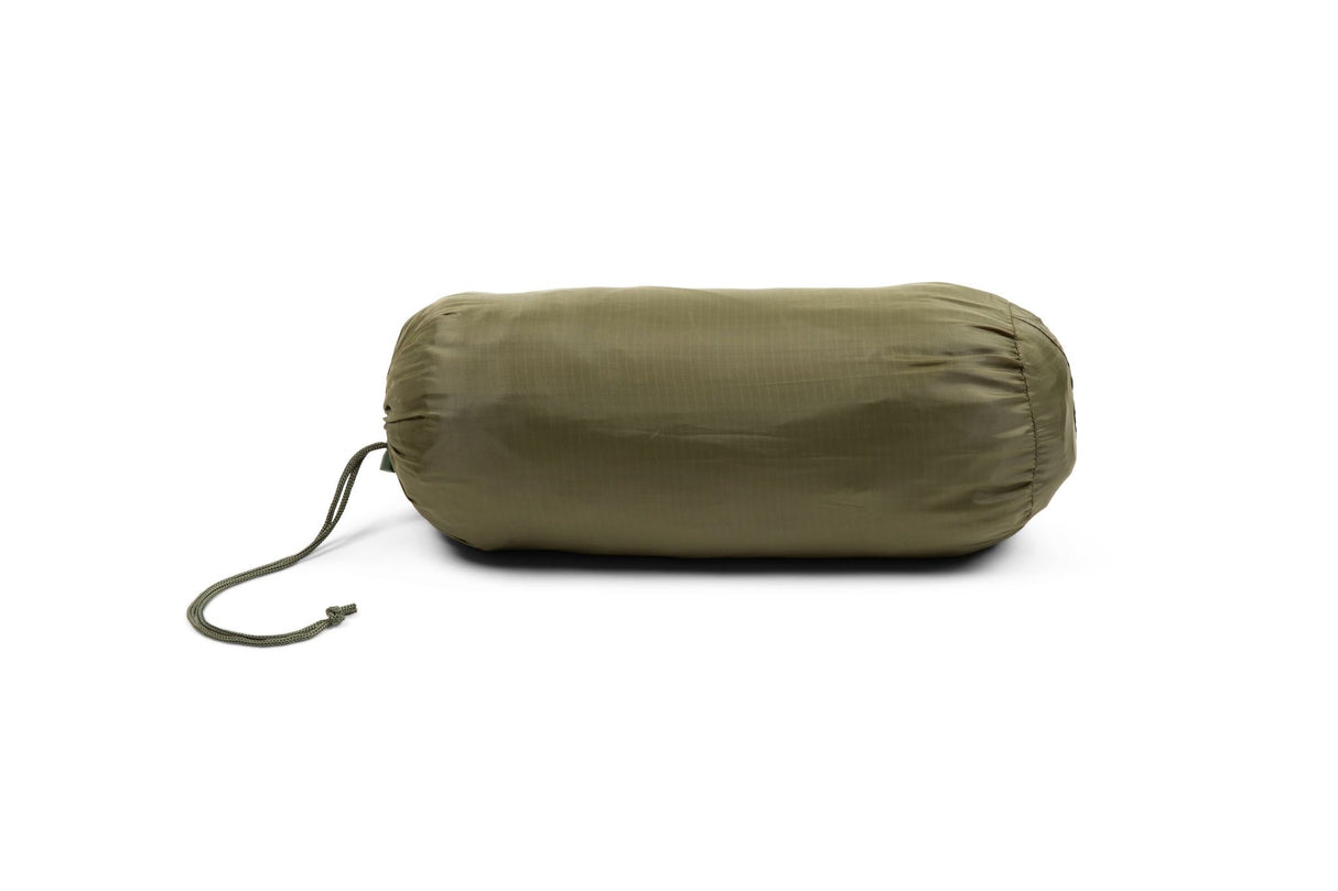 Green compression sack on a white background
