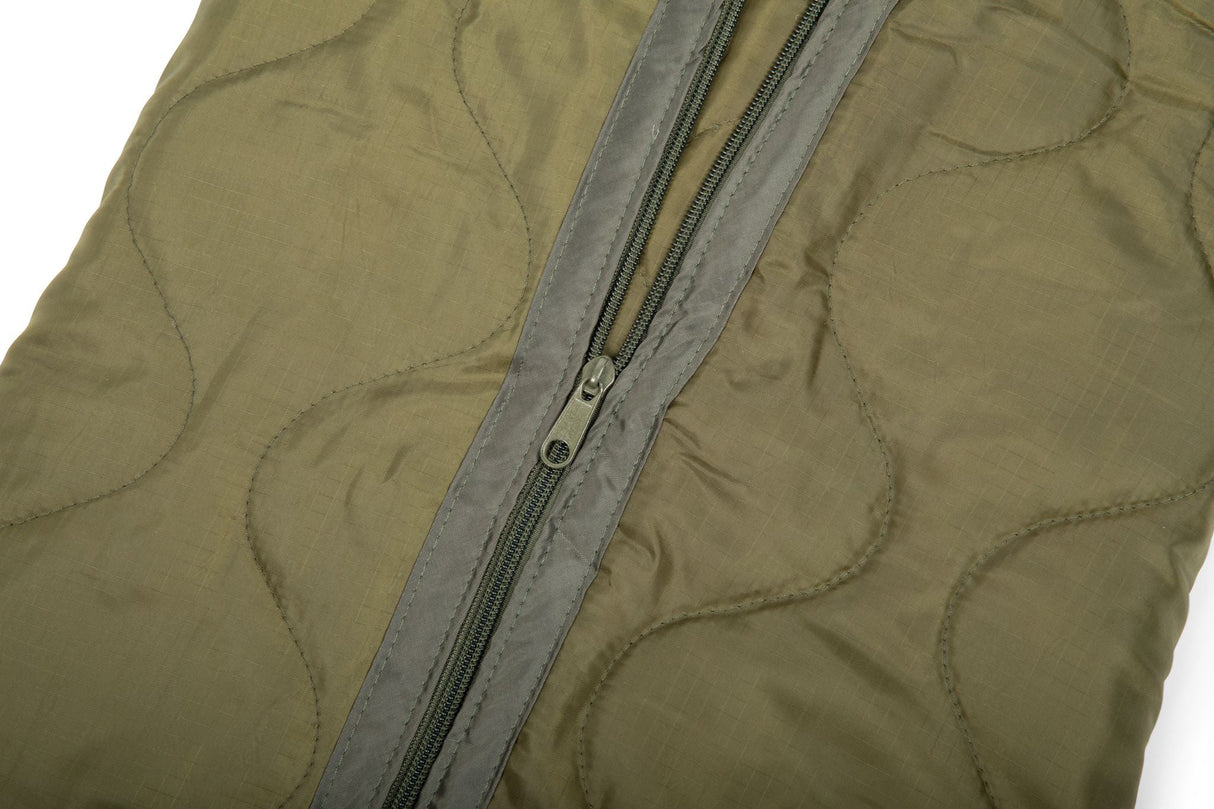 Close-up of a green jacket with a zipper on a white background