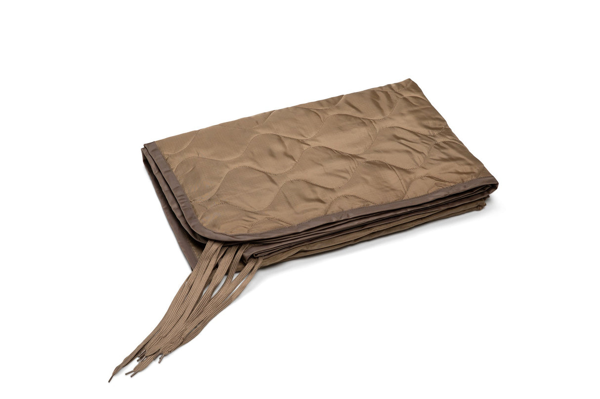 Brown quilted blanket with fringed edges on a white background