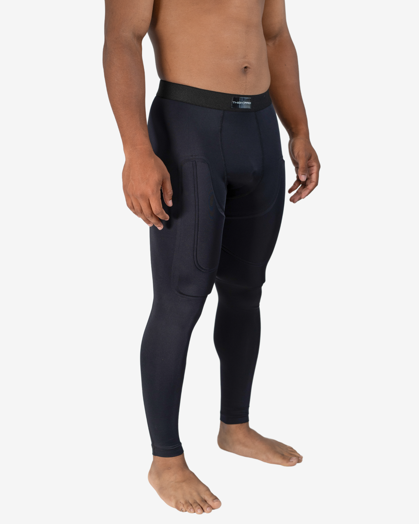 Person wearing black compression leggings on a white background