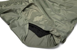 Green shorts with a close-up of the fabric on a white background