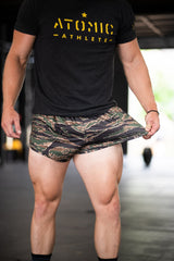 Person wearing a black 'Atomic Athlete' t-shirt and camouflage shorts.