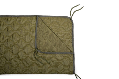 Green quilted blanket with gray border on a white background