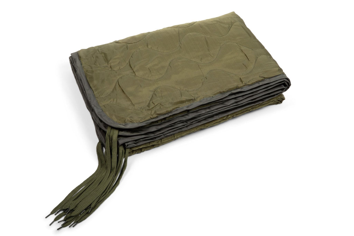 Folded green blanket with tassels on a white background